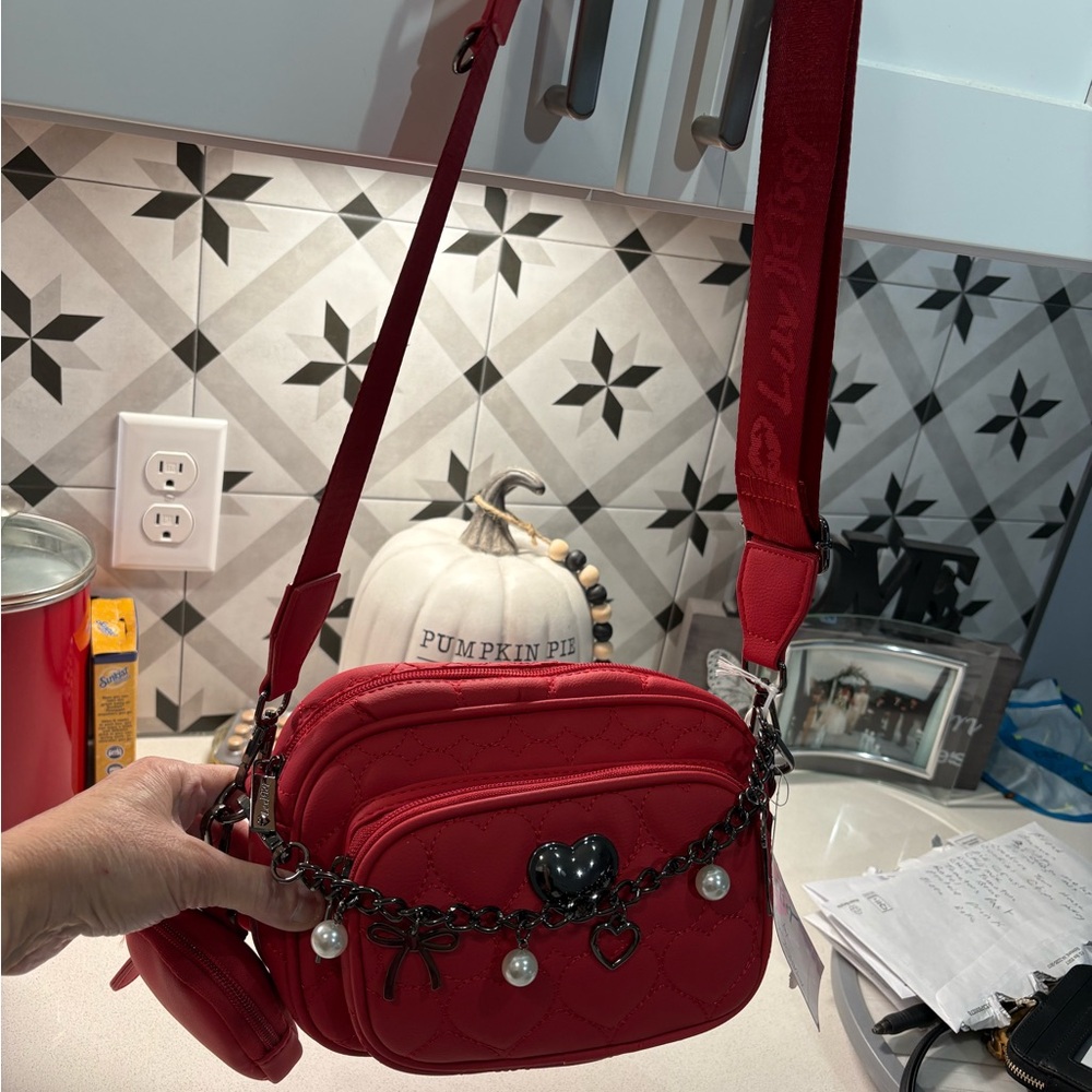 Red Quilted Betsy Johnson Crossbody Bag with beautiful chain across.